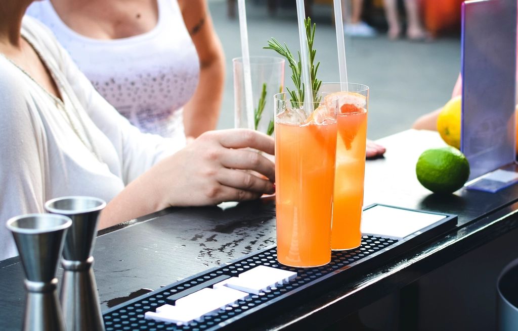 A cocktail being finished at the bar