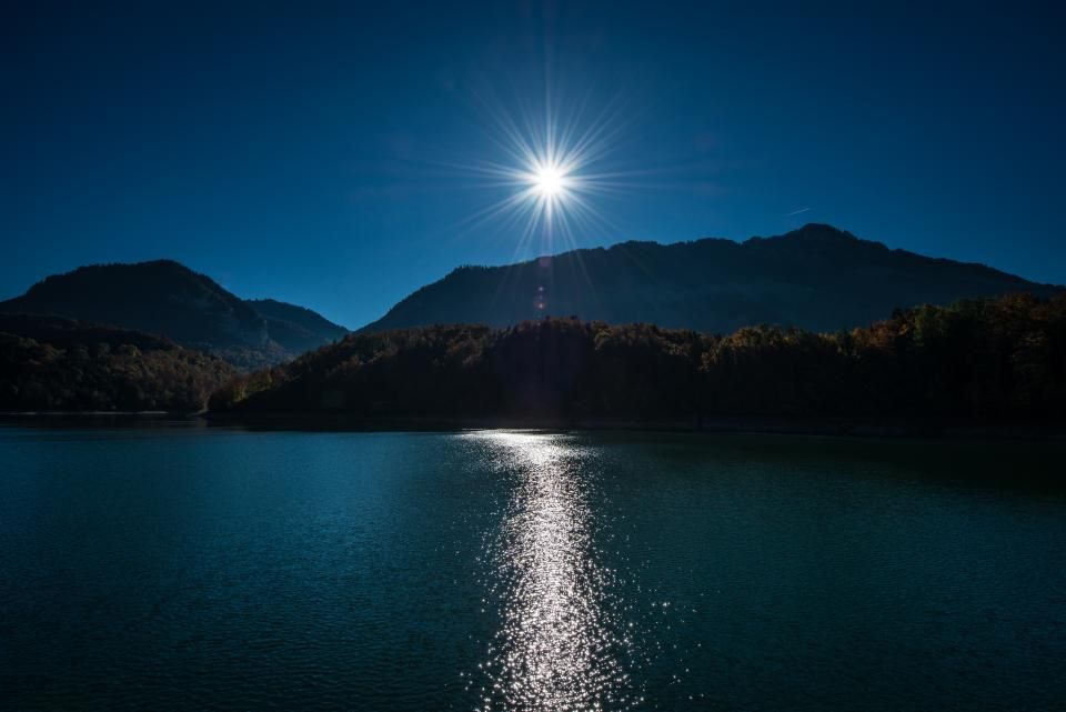 The lake, still, with hills behind