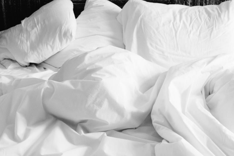 A guest room with a large bed and soft lighting